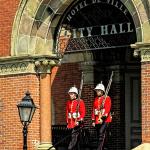 102.07 - "The City Guard, dressed in their colourful red tunics of the New Brunswick Regiment, performing their Sentry duty, which changes daily on the half-hour at Fredericton's City Hall during July and August."

