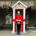 304.11 - "A Guard, dressed in his red serge jacket and pith helmet of the 1883 Royal Canadian Regiment, stands in front of the 'A' Company shelter outside of the Fredericton Region Museum.
"
